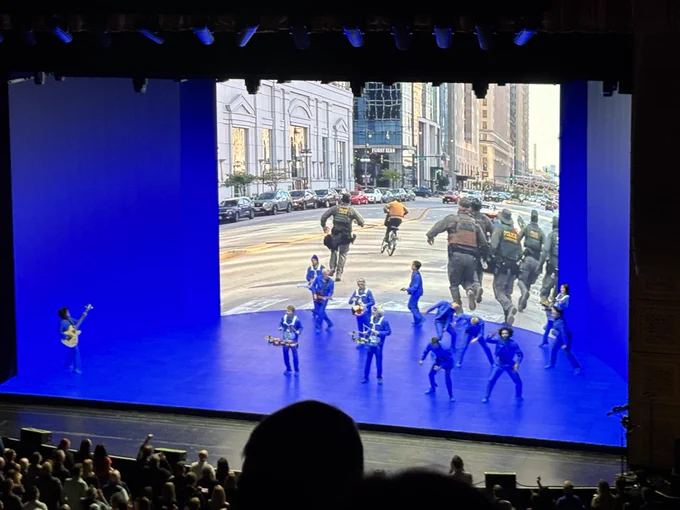 the video being projected behind all the performers on stage