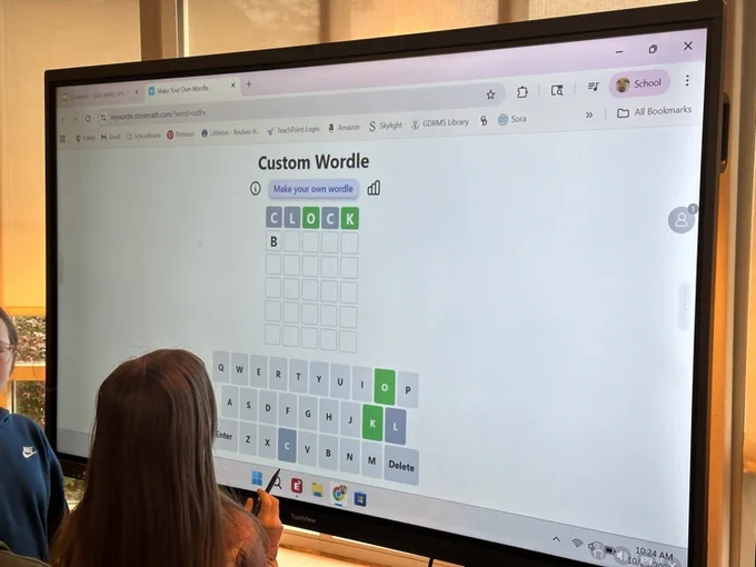 students working together on a interactive panel  