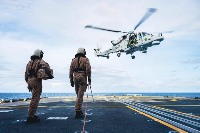 Sailor 1st Class Ruiz Lara (Left) and Sailor 1st Class Yianni Giannisis (Right) await Philippine Navy AW159 Wildcat's approach onto His Majesty's Canadian Ship MAX BERNAYS during Exercise SAMA SAMA at sea on 10 October 2025. 

Photo Credit: Sailor 1st Class Jordan Schilstra, Canadian Armed Forces Photo
