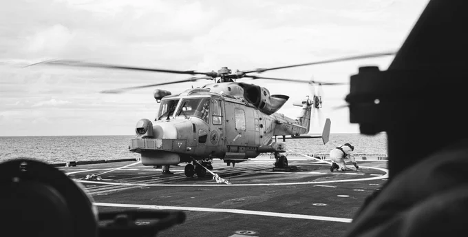 Members of His Majesty's Canadian Ship MAX BERNAYS assist with attaching Philippine Navy Helicopter AW159 Wildcat to the flight deck for Helo Operations as part of Exercise SAMA SAMA during Operation HORIZON at sea on 10 October 2025. 

Photo Credit: Sailor 1st Class Jordan Schilstra, Canadian Armed Forces Photo
