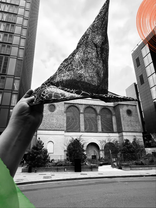 Liverpool Street, photographed in black and white. A witches hat is held up in the photo, and green and orange elements have been added to the picture.