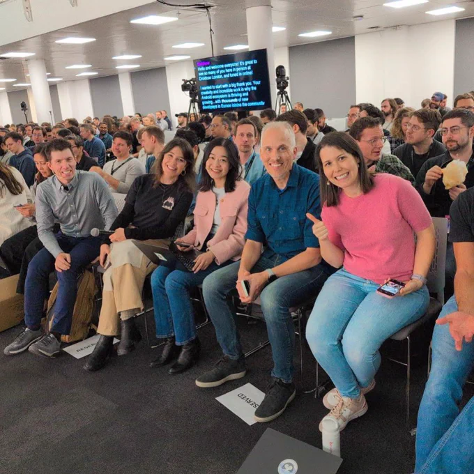 5 Ask Android panelists sitting in the front row of droidCon London smiling at the camera