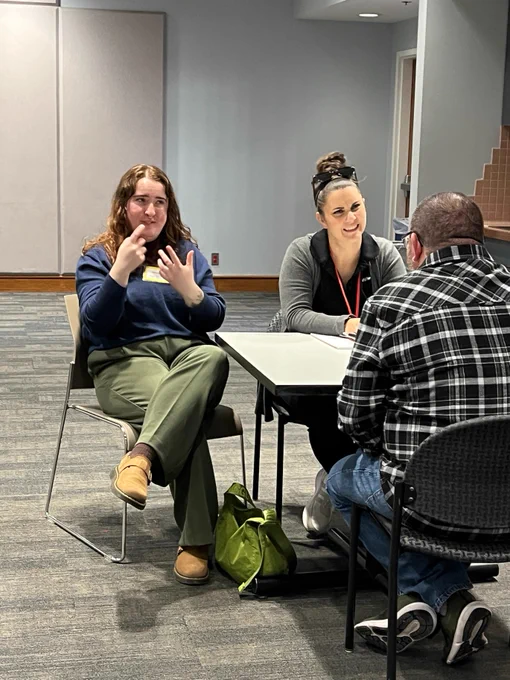 An OOD participant interviews with Laura Weikart, Associate Manager with CVS Workforce Initiatives, while an American Sign Language interpreter signs.