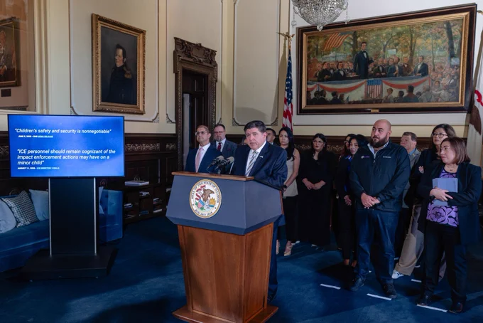 Governor Pritzker stands at a podium and speaks.