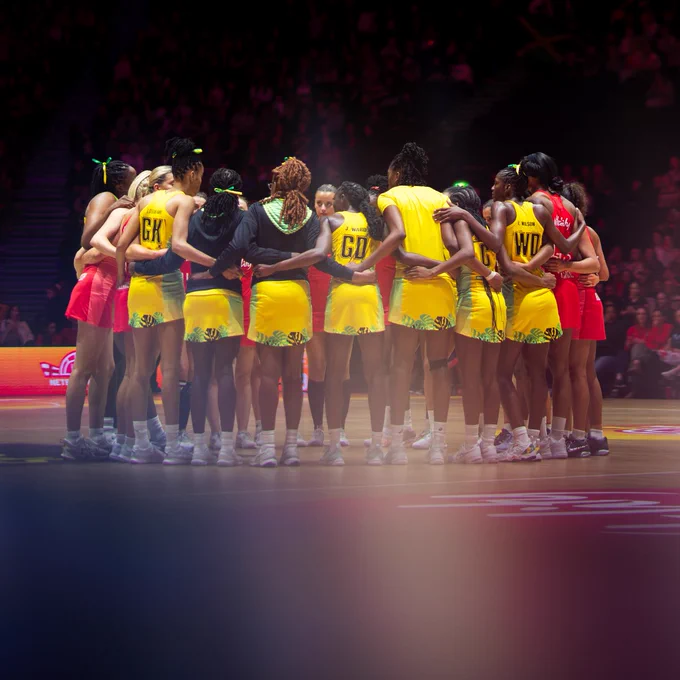 England and Jamaica stand in a huddle on court.