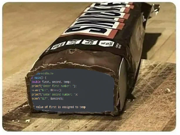 A snickers bar cut open with a basic example for how to swap two numbers using a temp variable in the C coding language