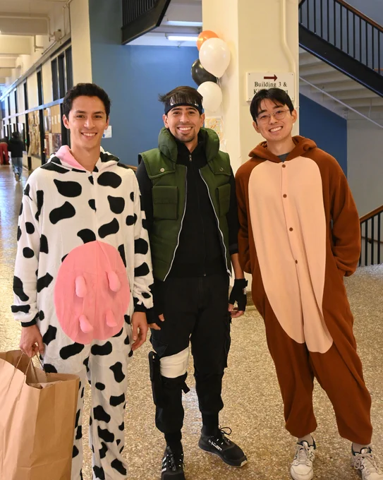 Three students in Halloween costumes.