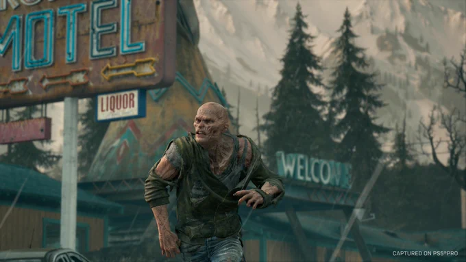 A screenshot from Days Gone Remastered showing a sole Freaker running toward the left side of the image. The backdrop consists of pine trees and a rundown motel.