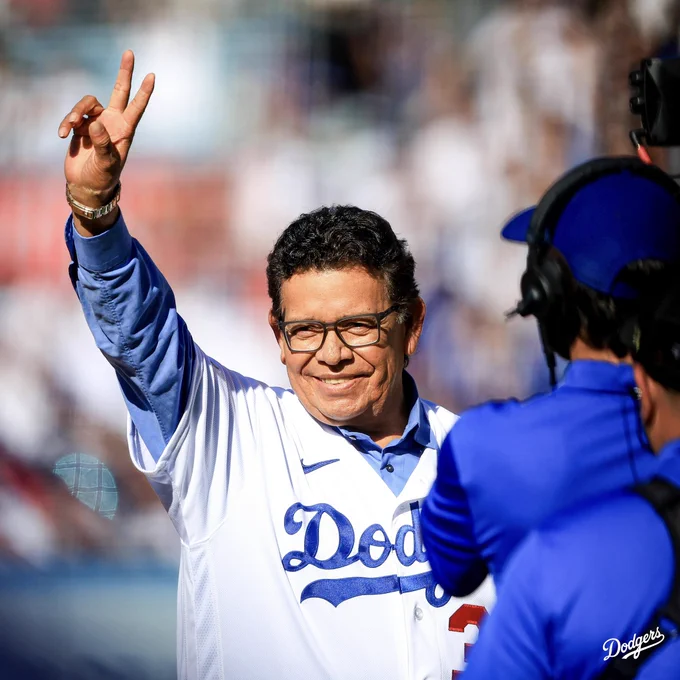 A photo of Fernando Valenzuela on the field at Dodger Stadium giving the peace sign to the fans.