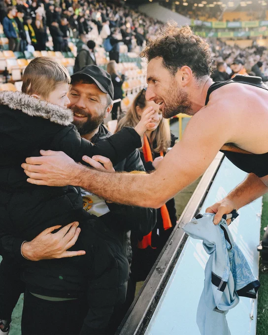 Lewie Coyle gives his shirt to a young fan