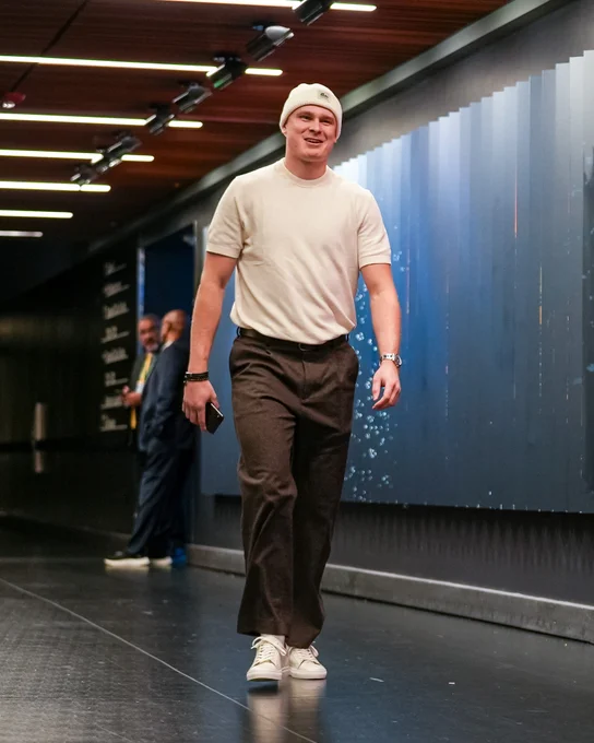 Photo of Kaapo smiling walking in to arena for matchup with Rangers.