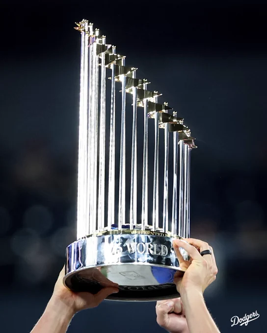 A photo of the World Series trophy being held in the air.