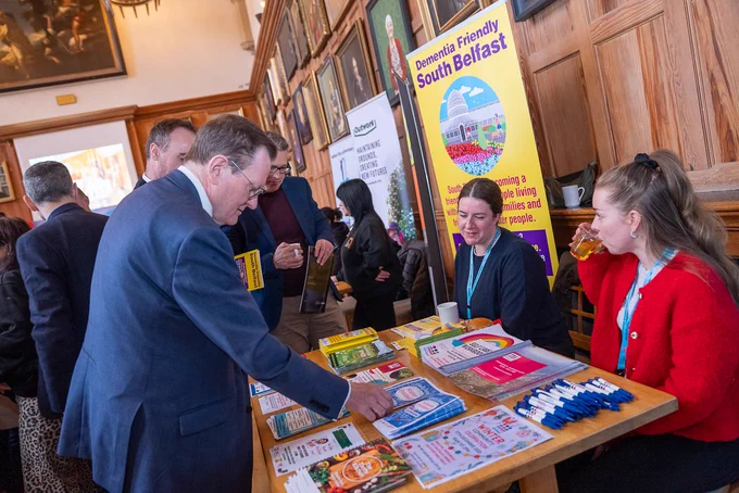 Image shows Professor Sir Ian Greer visiting one of the stalls at the event, 'Dementia Friendly South Belfast'.