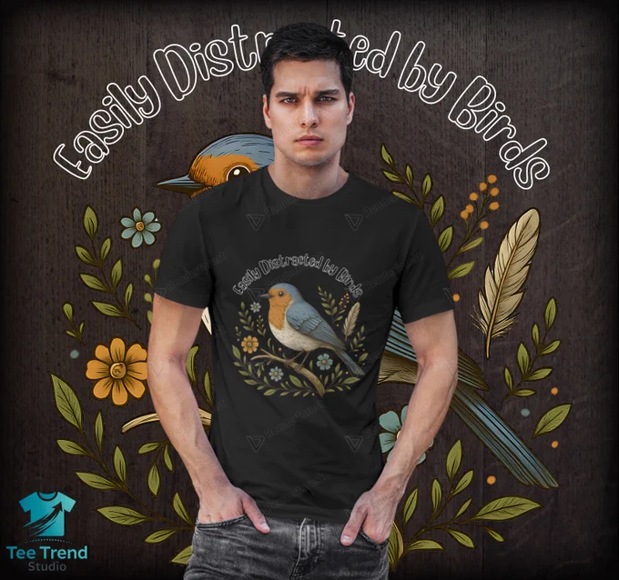 Show your love for nature with this charming “Easily Distracted by Birds” T-shirt featuring a beautifully illustrated bird surrounded by colorful flowers and leaves. Perfect for bird watchers, nature lovers, and a cozy and stylish gift for outdoor enthusiasts.