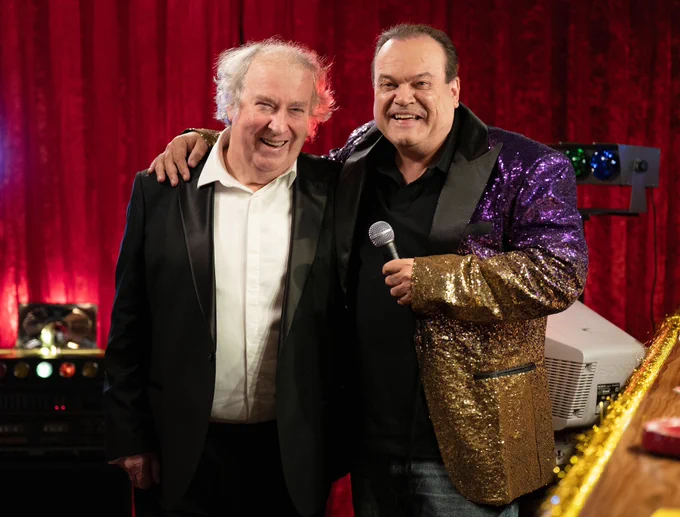 Barry smiles as he stands with Nigel in EastEnders