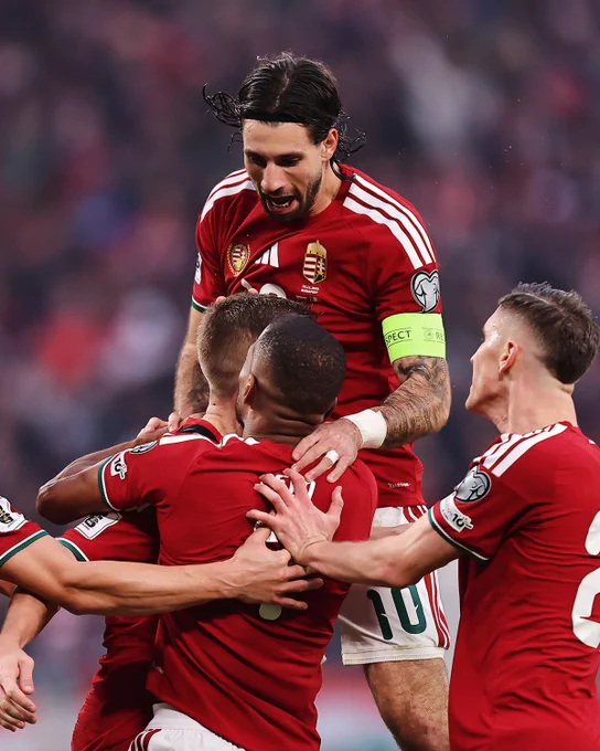 Photography of Dominik Szoboszlai celebrating with his teammates with the Hungary National Team.