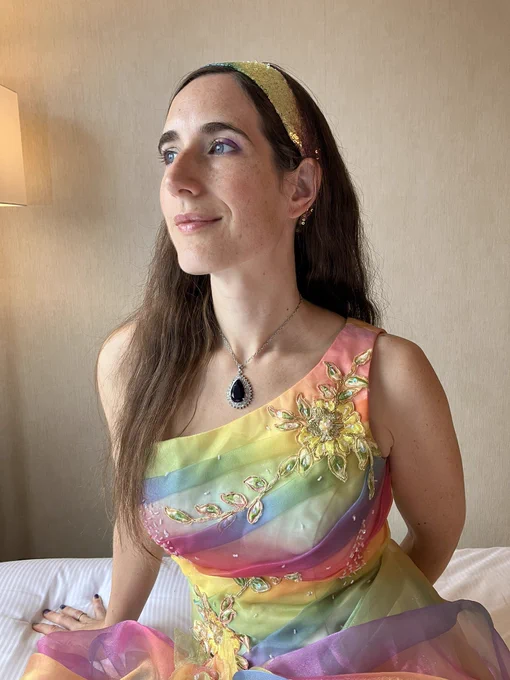 Author in rainbow dress with ‘cursed’ necklace