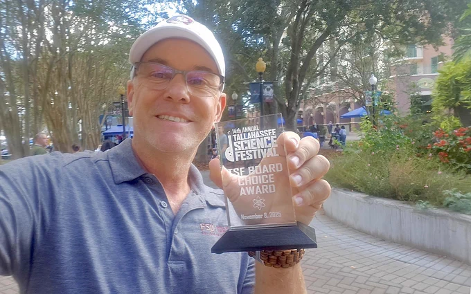 Florida State University's Science on the Move program won the Board Choice Award during this year's Tallahassee Science Festival. Charles Carpenter, director of Science on the Move, is pictured holding the award.