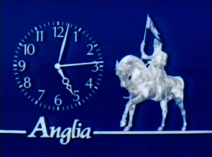 A clockface showing 5:14, with the Anglia TV knight on horseback and the word Anglia. These features are white and silver on a blue background.