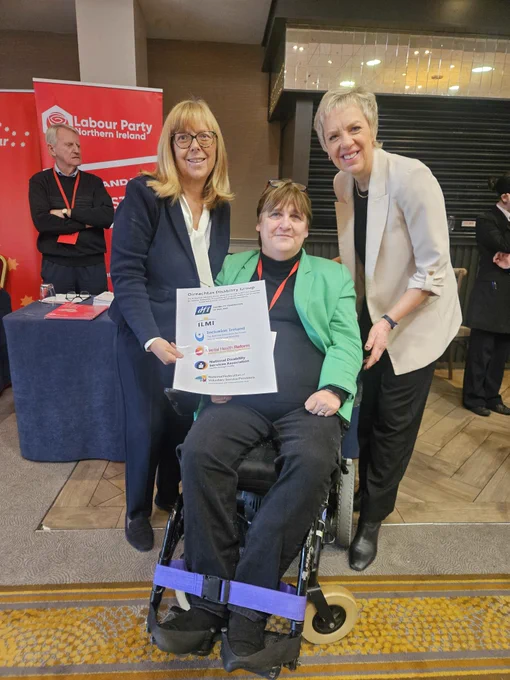 Emer Costello and Joan Carthy with Labour Party Leader Ivana Bacik with the Oireachtas Disability Group poster with logos of member organisations  