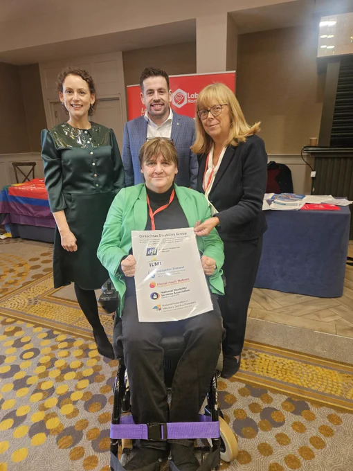 Labour TDs Marie Sherlock and Conor Sheehan with Joan Carthy and EmerCostello - holding the Oireachtas Disability Group Poster of member logos 