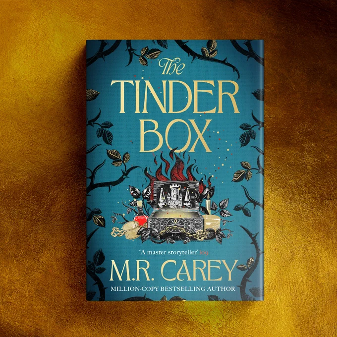 against a gold background sits a hardback copy of The Tinder Box.