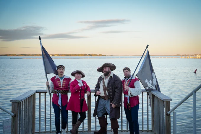 HeroDevs team at ng-conf. Dressed in Pirate clothes standing on pier. 