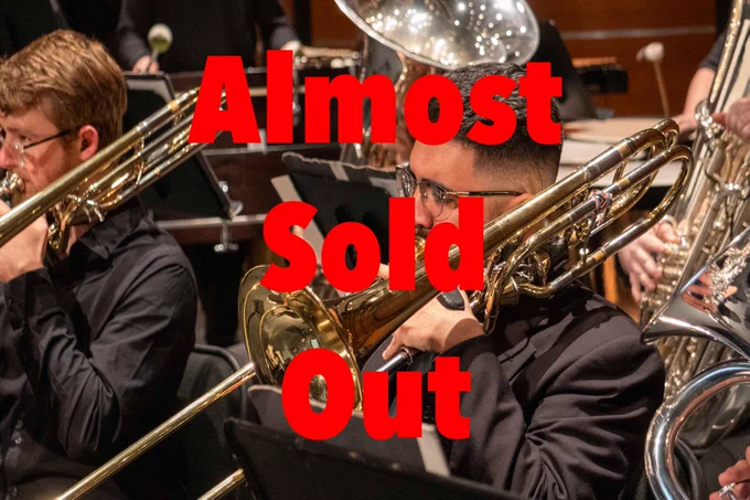 Musicians playing trombones in an orchestra with a text overlay saying 'Almost Sold Out'.
