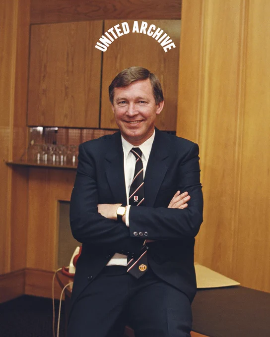 Sir Alex Ferguson in his office, with the United Archive logo above his head.