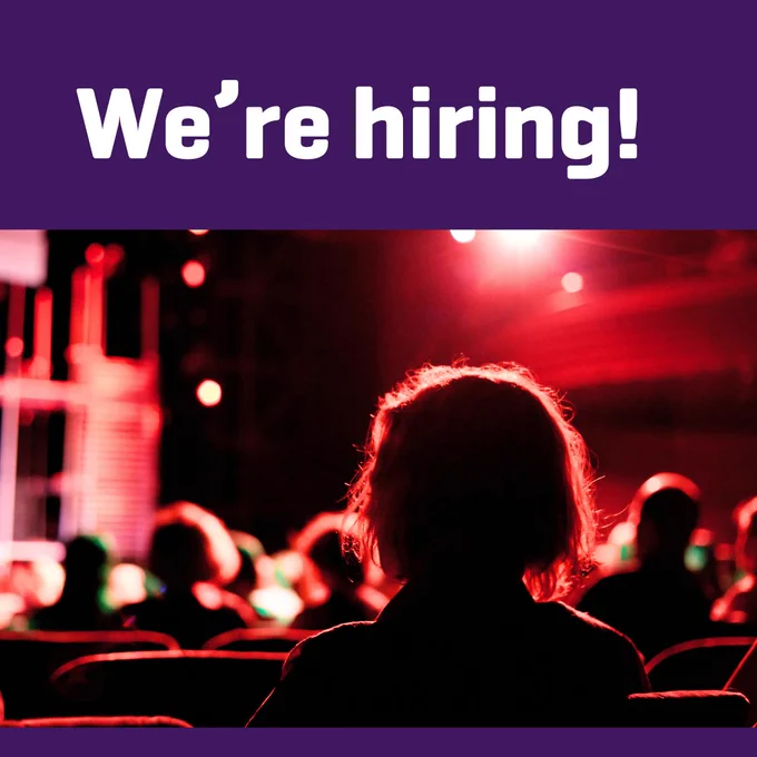 Image of the back of an audience member's head. Text above says "We're hiring!"