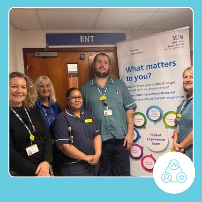 A picture of a group of medical staff, the patient experience lead at southend hospital and a volunteer in the ear nose and throat department by the patient experience banner.