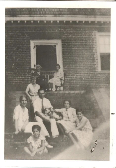 DeFrees family and their dog pose for a picture outside of the Francis Land House.
