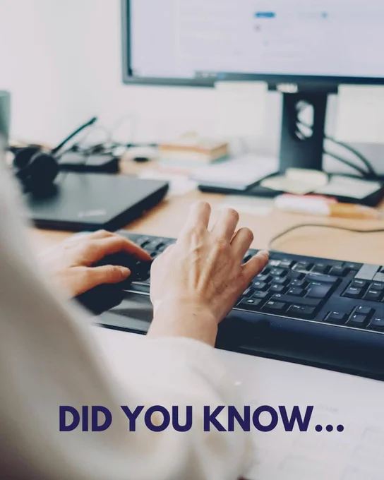 Person typing on a keyboard with a blurred background featuring a desktop computer and a "Did You Know..." text overlay.