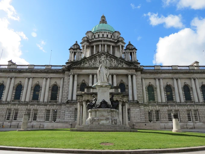Front of Belfast City Hall building showing part of the lawn