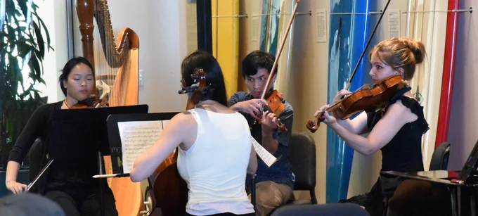 Students playing string instruments.