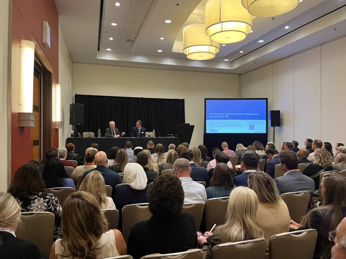 Joint Commission Chief Nursing Executive Ken Grubbs speaks at Becker's Healthcare annual meeting. Photo is a wide shot showing a large crowd gathered to watch the session.