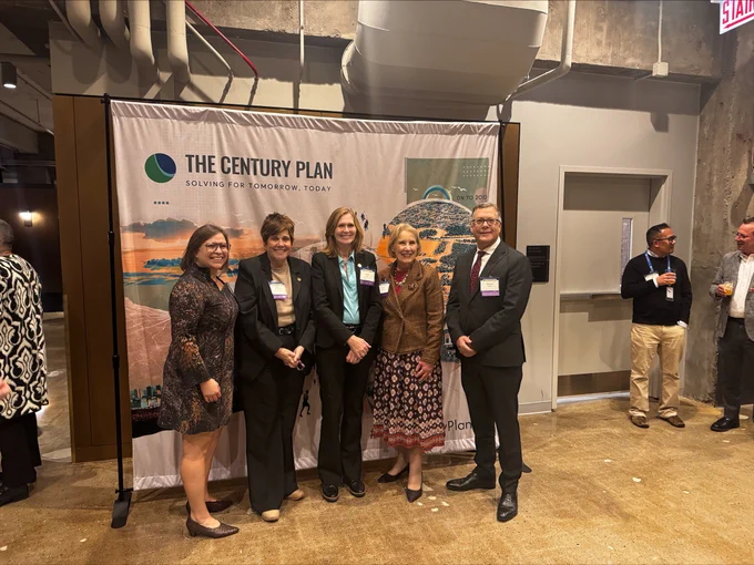 This is a photo of McHenry County Board Chairman Mike Buehler standing with the chairpeople of the other collar counties at the CMAP State of the Region Event.