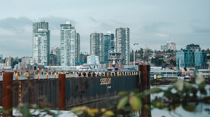 A Seaspan Ferries barge and tugboat overlook the New Westminster waterfront (Photo Credit: UBC Applied Science / Andrew Wang, UBC Studios).