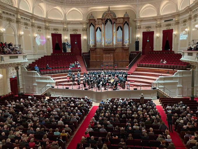 The Early Opera Company standing on the stage at the Royal Concertgebouw, Amsterdam. 