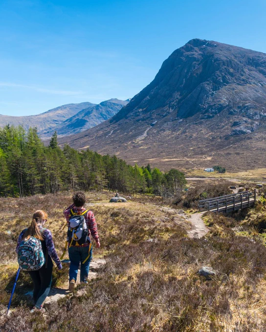 Hikers look at scenery in the Scottish Highlands.