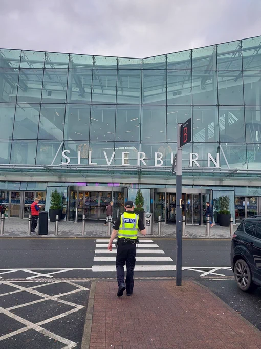 Officer in hi-viz walking outside Silverburn