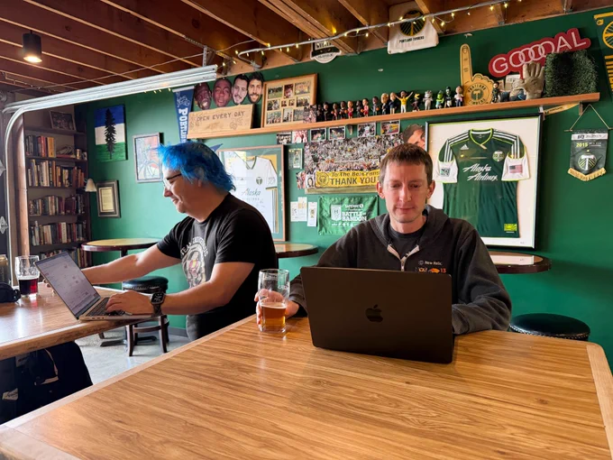Ben and me rotating secrets while having beers. Timbers soccer paraphernalia lines the wall behind us.