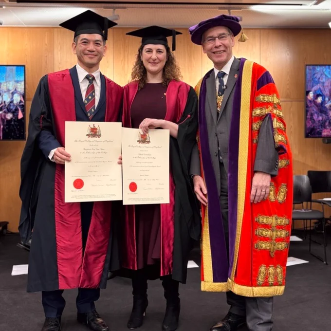Diplomates Benjamin Kai Yan Chan and Klaire Exarchou stand on stage with RCS England President, Tim Mitchell 