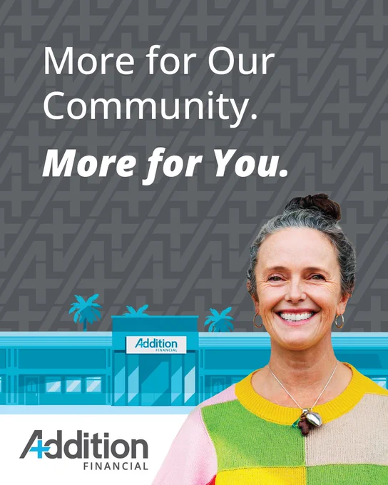 Advertisement poster featuring a smiling person in a colorful sweater, with the text 'More for Our Community. More for You.' The background includes a stylized image of Addition Financial's building and logo.