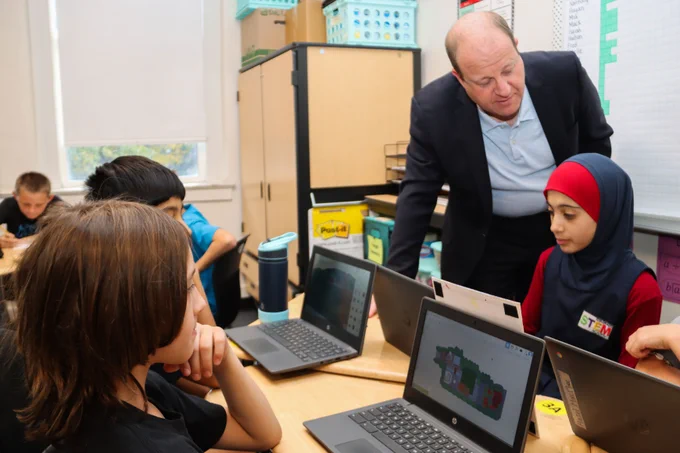 Governor Jared Polis observing students at STEM Academy on their classroom laptops, October 16th, 2024.