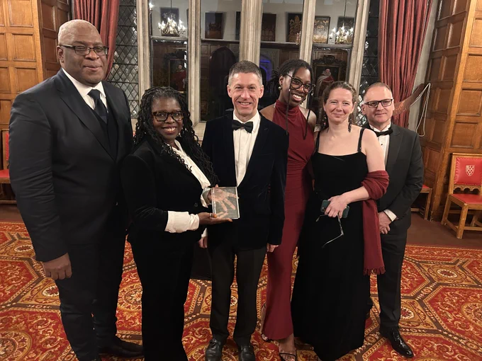 L to R: Professor Simon Anderson, Co-Director of the Glasgow Caribbean Centre for Development Research; Dr Peggy Brunache, Director of the Beniba Centre for Slavery Studies; Dr David Duncan, UofG's Chief Operating Officer & Deputy Vice Chancellor; Taylar Carty, James McCune PhD scholar; Dr Christine Whyte, Historian and Dr Stephen Mullen, Historian and co-author of the 2018 Slavery, Abolition & the University of Glasgow report are photographed with the UWI Chancellor's Award.