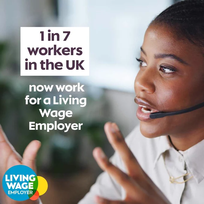 Photo of a young black woman speaking on the phone via a headset, with text reading: '1 in 7 workers in the UK now work for a Living Wage Employer'.  