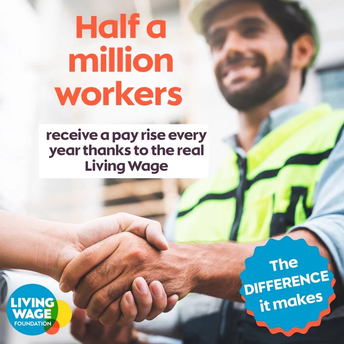 Photo of a male worker in a high vis jacket shaking hands with someone out of frame and smiling, with text reading: 'Half a million workers receive a pay rise every year thanks to the real Living Wage'.  