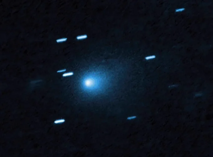 An image of the interstellar comet 3I/ATLAS, as captured by NASA's Hubble Space Telescope on July 21, 2025. The bluish-white comet shines bright among a handful of bluish streaks. Credit: NASA, ESA, David Jewitt (UCLA); Image Processing: Joseph DePasquale (STScI)