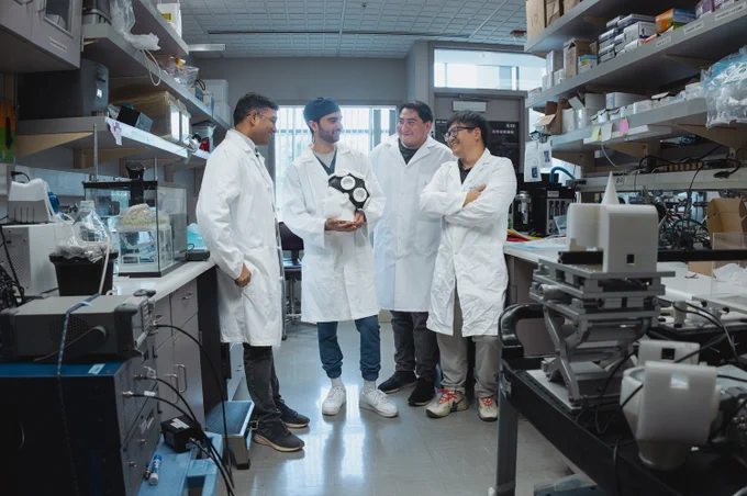 Raag Airan, Matine Azadian, Payton Martinez and Yun Xiang in the lab. Azadian is holding a version of their ultrasound apparatus designed for humans.